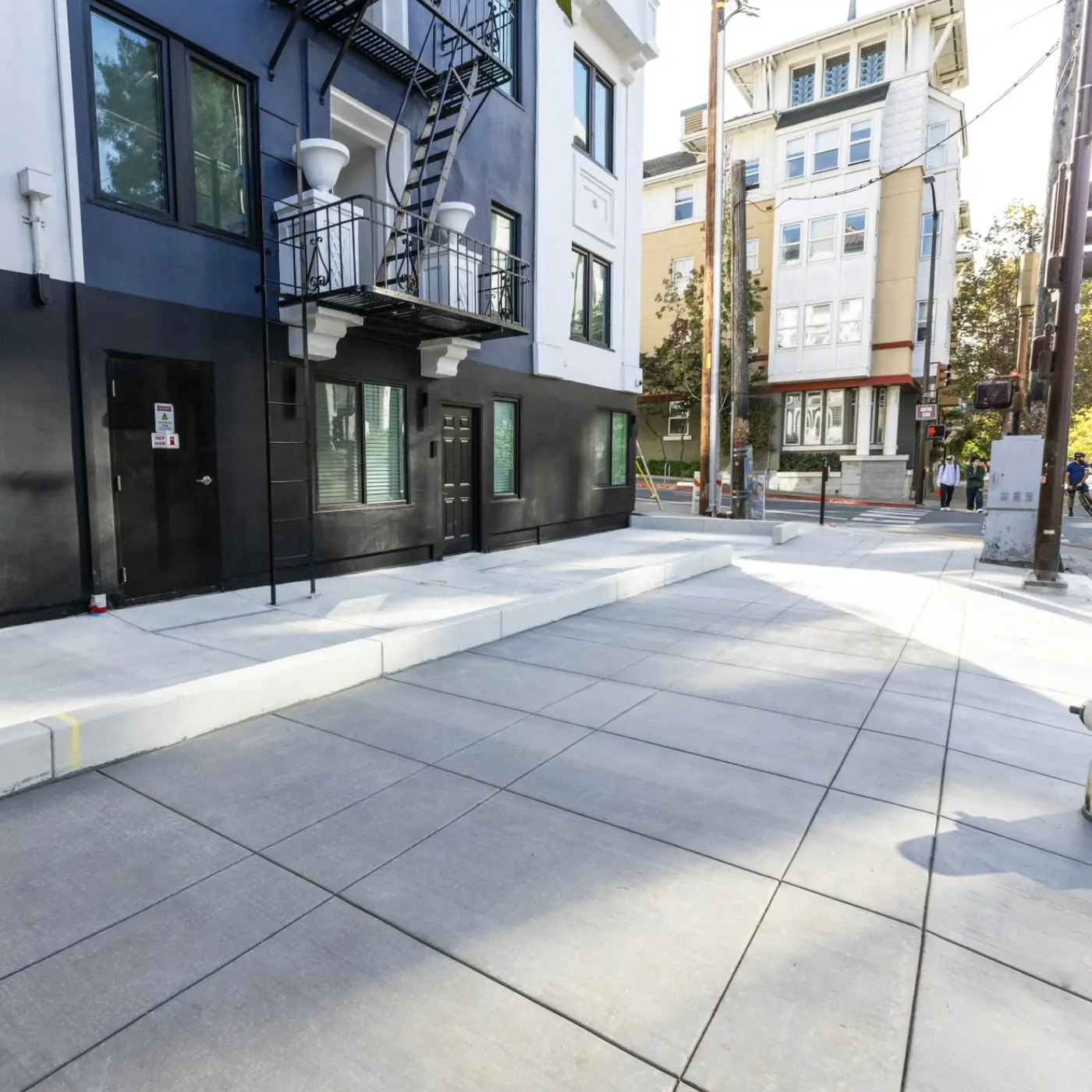 Wide ground-level sidewalk + curb cut at corner — Durant Sidewalk — UC Berkeley, Berkeley, CA