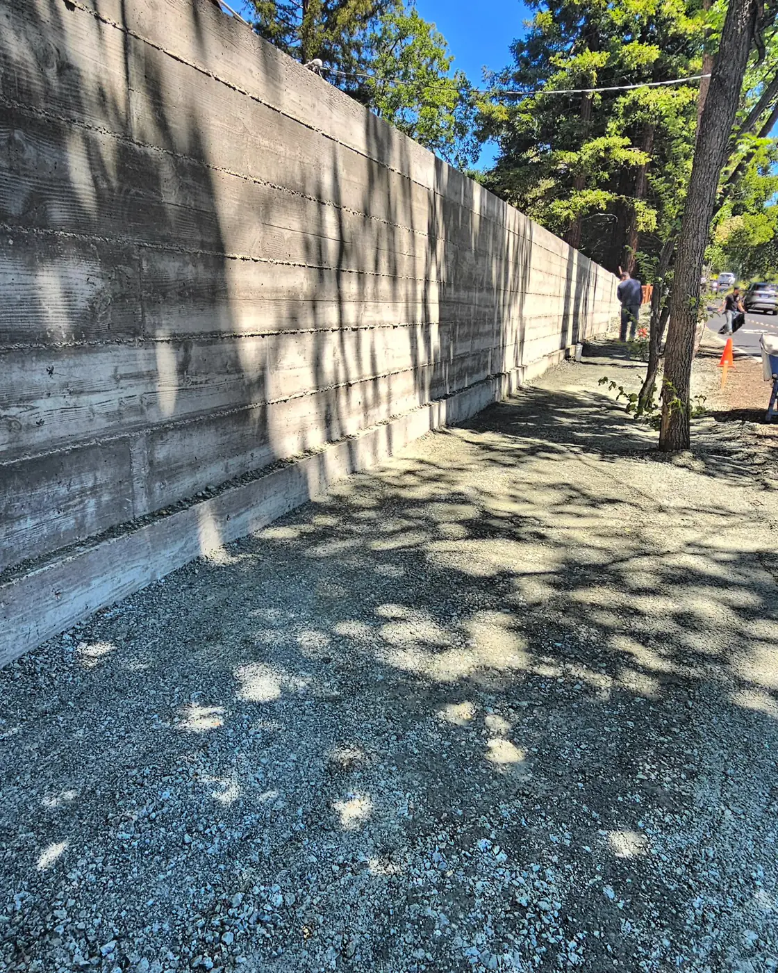 Completed board-formed wall along gravel path, tree shadow — Sound Wall Replacement — Diablo Country Club, Danville, CA
