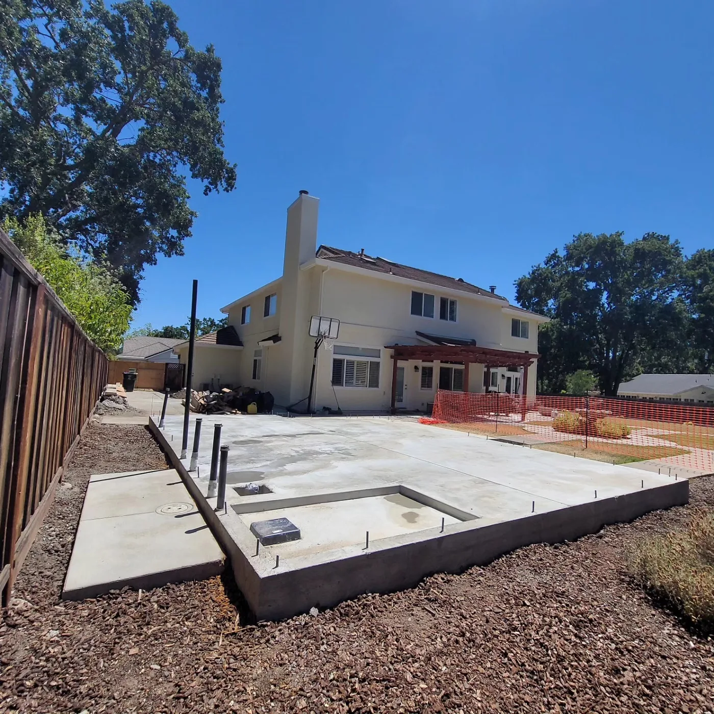 The finished raised slab and patio with the recessed curbless-shower drop, main house behind — Alamo ADU Foundation, Alamo, CA