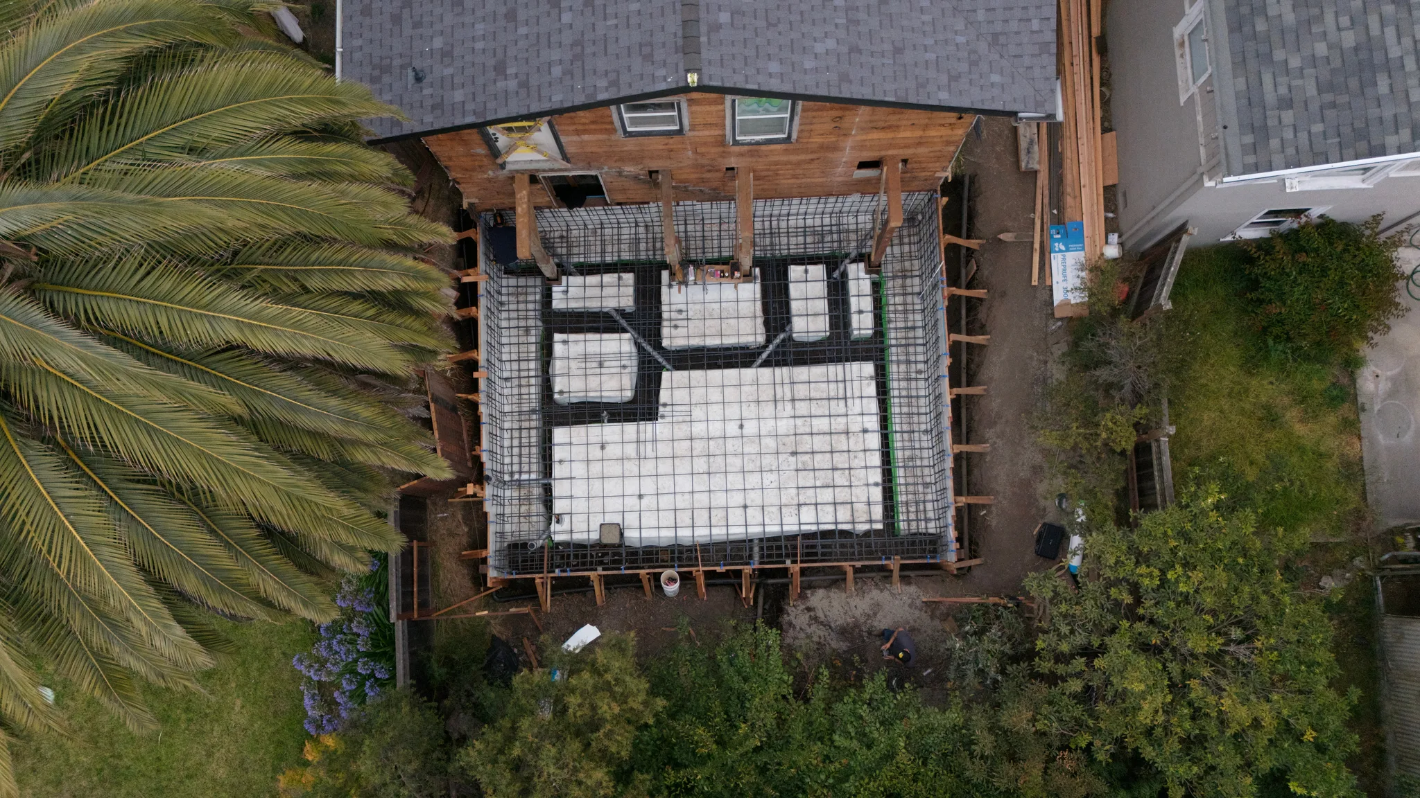 Aerial of the void-form raised slab laid out inside the braced perimeter forms — Albany Home Addition Foundation, Albany, CA