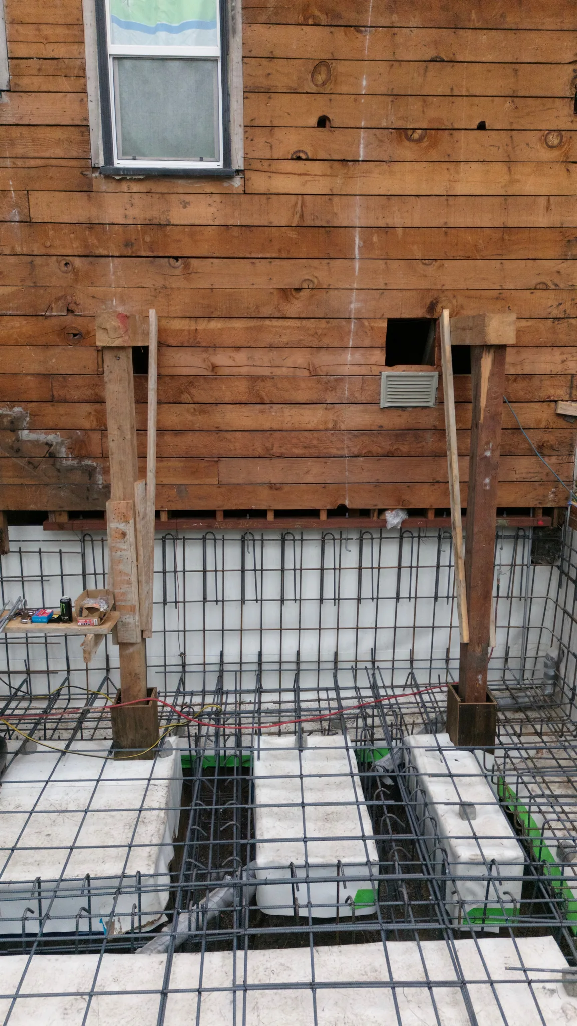 Shoring posts landed between grade beams beneath the home's rear wall — Albany Home Addition Foundation, Albany, CA