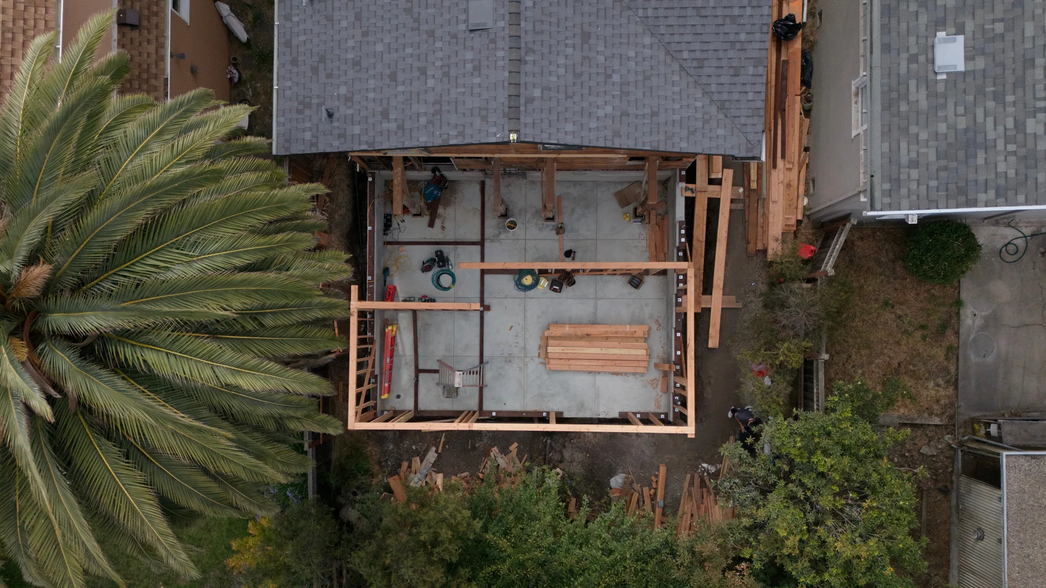 Top-down view of the cured slab weeks later, FitzBuild's wall framing underway — Albany Home Addition Foundation, Albany, CA