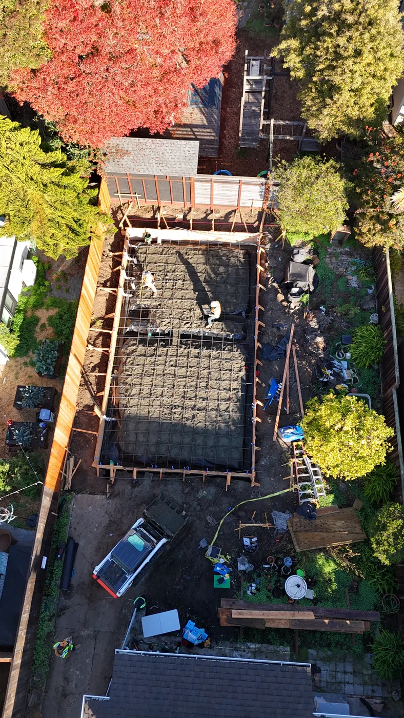 Crew setting the rebar mat inside the formed footprint, seen from directly above — Berkeley Backyard Detached ADU, Berkeley, CA