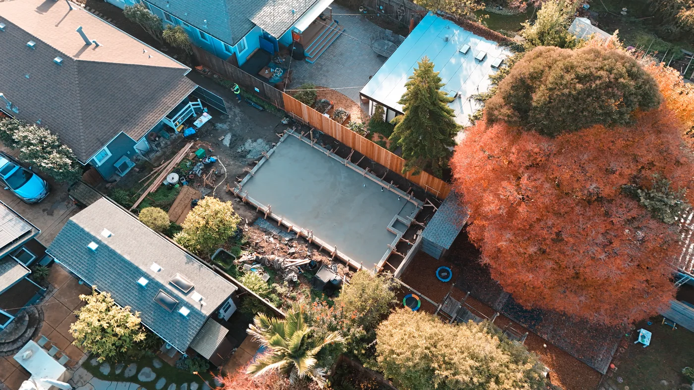 Wide aerial of the finished ADU slab set among the surrounding Berkeley homes and gardens — Berkeley Backyard Detached ADU, Berkeley, CA