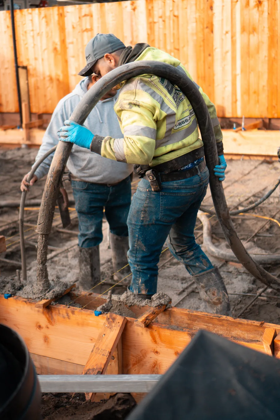 Crew placing concrete through the pump hose into the formed slab — Berkeley Backyard Detached ADU, Berkeley, CA