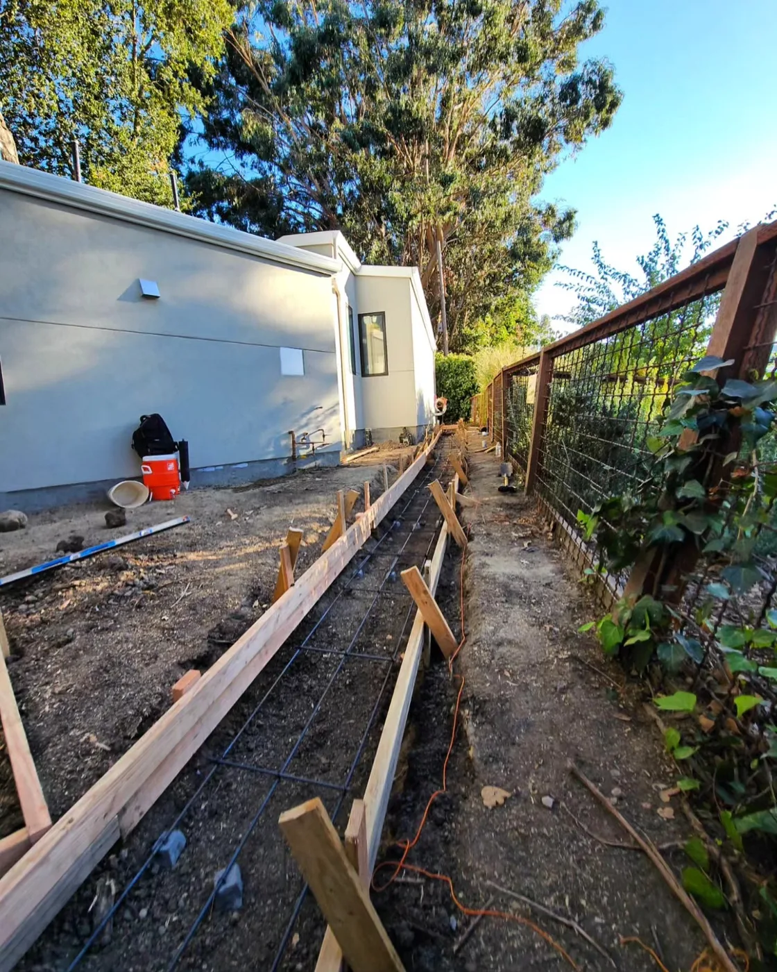 Formwork and wire-mesh reinforcement staked out for the drainage channel run — Danville Landing Pad & Curb Drainage, Danville, CA