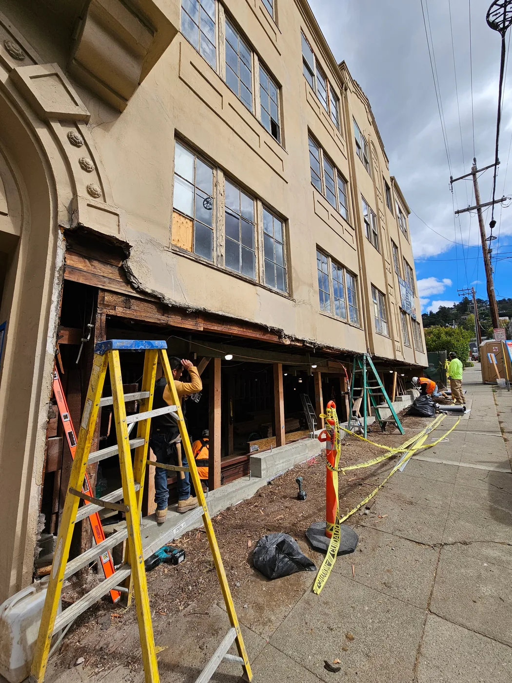 The facade shored along the sidewalk during structural work at the ground floor — Durant Basement Foundation, Berkeley, CA
