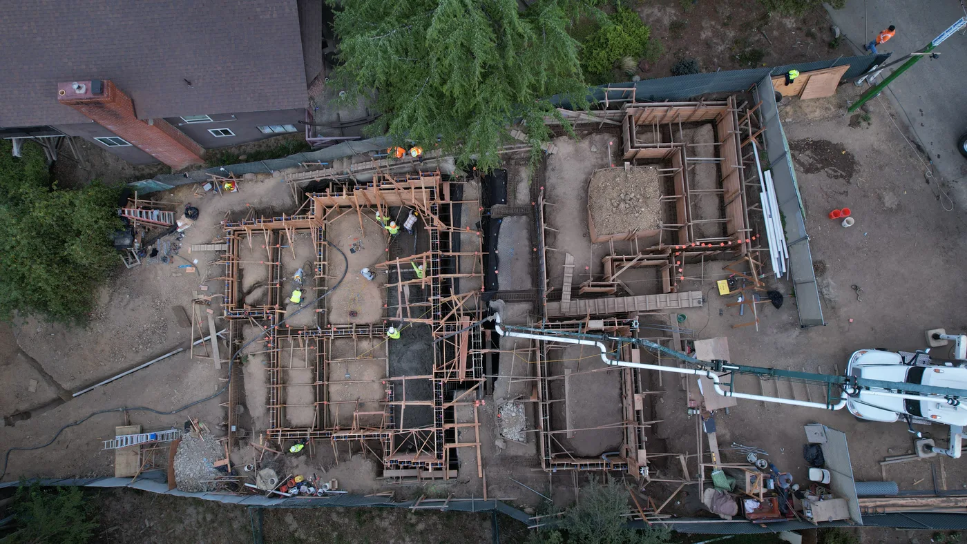 Top-down aerial of the formed foundation walls before the pour — Oakland Hills Custom Home, Oakland, CA
