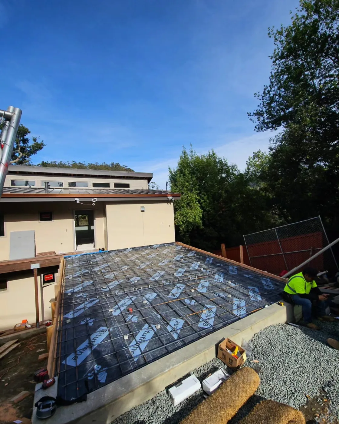 What a driveway looks like before the concrete: waterproofing membrane and a full rebar mat — Richmond