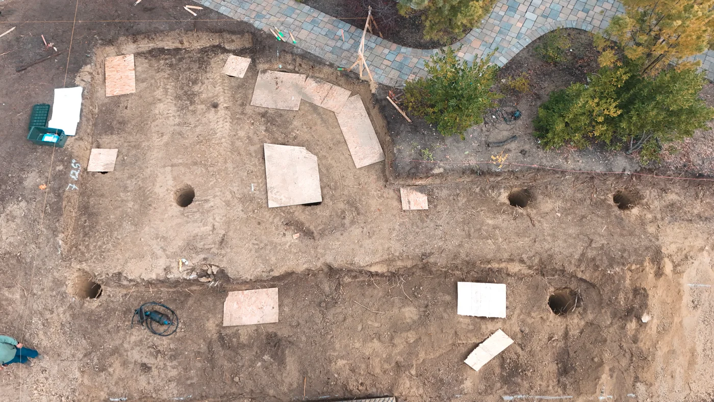 Close aerial of the drilled pier holes and footing trenches cut into the graded pad — Steep Hillside Lafayette ADU, Lafayette, CA