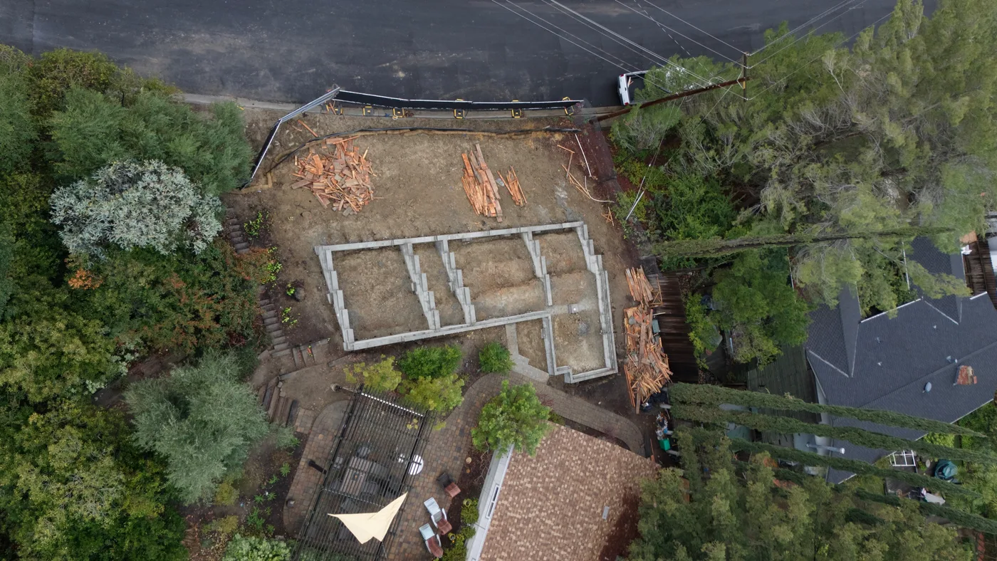 Top-down aerial of the completed foundation with its interior bearing walls laid out across the pad — Steep Hillside Lafayette ADU, Lafayette, CA